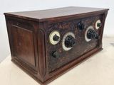 an old fashioned wooden radio sitting on top of a table