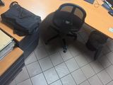 a desk with a chair and a computer monitor on it