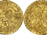 two gold coins, one of which has a cross and the other of which has a cross on it