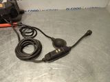 a close up of a cord connected to a microphone on a metal surface