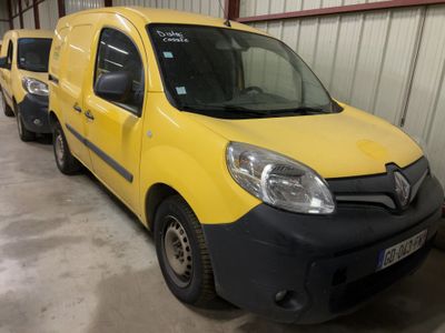 yellow van parked in a garage with other vans in the background