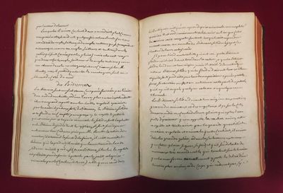 an open book with writing on it sitting on a table