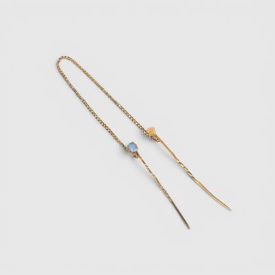 a pair of gold plated earrings with blue glass beads