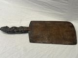a wooden cutting board and a knife on a table