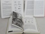 three open books sitting on a table next to each other