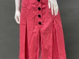 a mannequin wearing a pink skirt with buttons on it