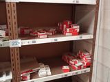 many boxes of cigarettes on the shelves in the store