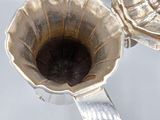 two silver cups that are sitting next to each other