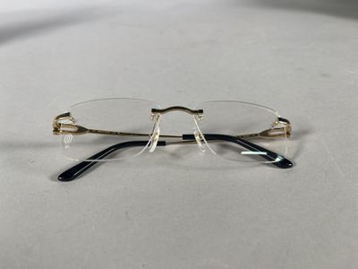 a pair of glasses sitting on a table next to each other