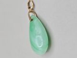 a green jade tear pendant on a gold plated chain