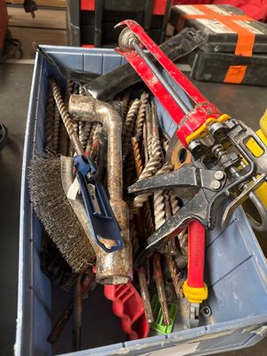 a bin full of tools that are sitting on the floor