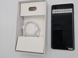 a box with a phone and a charger in it