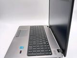 a silver laptop with a black keyboard on a white surface