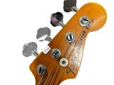 the headstock of an electric bass guitar on a white background