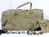 a duffel bag with a lot of items on the table