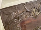 a metal box with a bird and a bird on it