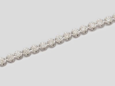 a close up of a diamond necklace on a white background