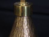 a close up of a brass bell on a black background