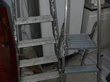 a ladder that is leaning against the wall in the kitchen