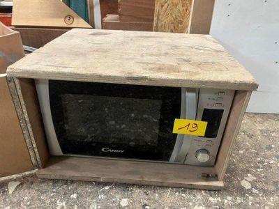a microwave sitting in a box with a price tag on it