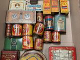 an open box filled with assorted tins and tin cans