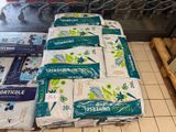 many bags of toilet paper sitting on the floor