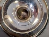 a silver plate with a hole in it on a table