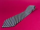 a black and white tie on a pink background