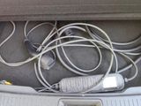 a bunch of wires and cords in the trunk of a car
