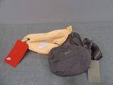 a bag and a fanny bag sitting on a bed
