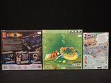 three video games on the table in front of a black background