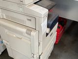 a stack of printers sitting on top of each other in a warehouse