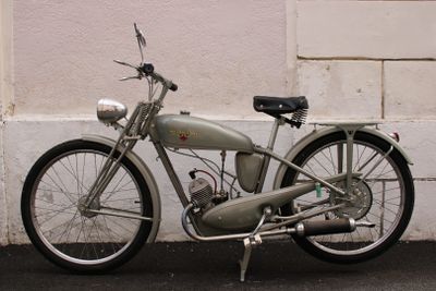 a old motorcycle parked on the side of the street