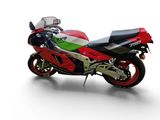 a red and green motorcycle parked on a white surface