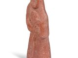 figurine of a woman holding a child in her arms on a white background