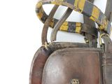 a brown purse with a yellow and black stripe on it