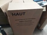 a cardboard box with a sign on it that says haut