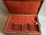 a wooden box that has a bunch of empty trays inside of it