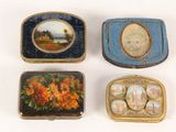 three small boxes with paintings on them are sitting on a white surface