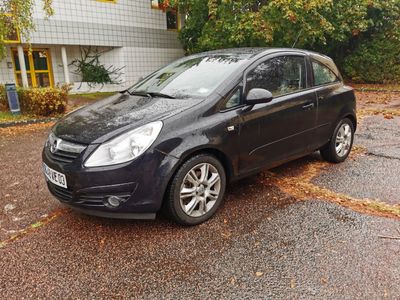 a small black car parked in a parking lot