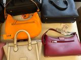 many different purses on a table in a store