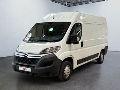 the white van is parked in the large room of the building