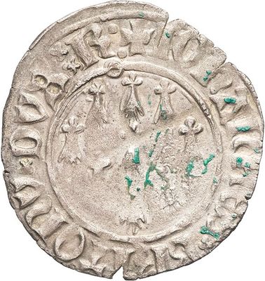 a close up of a coin with green paint on it