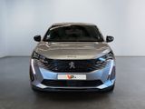 the front view of a silver car in a white room