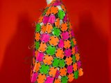 an image of a mannequin with flowers on it against a red background