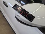 a sticker on the side mirror of a white car