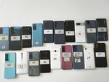 a lot of cell phones that are sitting on a table