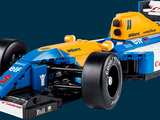 a blue and yellow race car with a man in the background