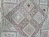 an image of a white and brown quilt on a bed