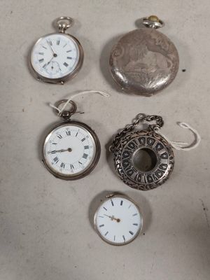 many different types of pocket watches on the table